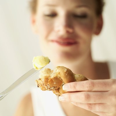 Stockbyte/Stockbyte/Getty Images Butter is high in cholesterol and saturated fat.