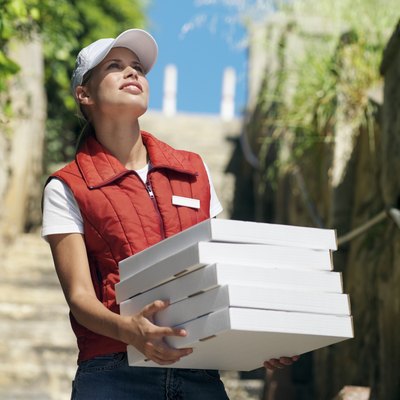 Stockbyte/Stockbyte/Getty Images Pizza deliverers earn a significant portion of their income from tips.