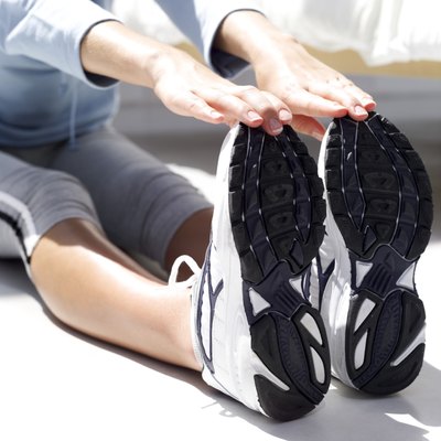 Stockbyte/Stockbyte/Getty Images Keep the working knee straight to target the outer calf muscle..