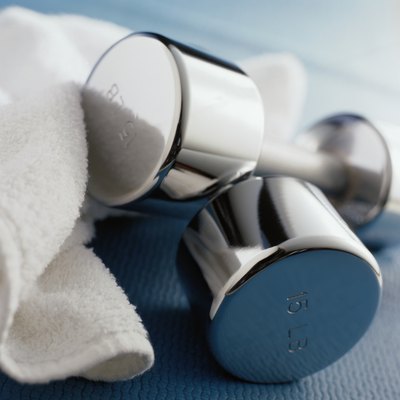 Duncan Smith/Photodisc/Getty Images Start with dumbbells of a lower weight and work up as you get stronger.
