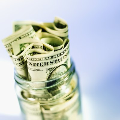Stockbyte/Stockbyte/Getty Images Money jars can help you track and control spending.