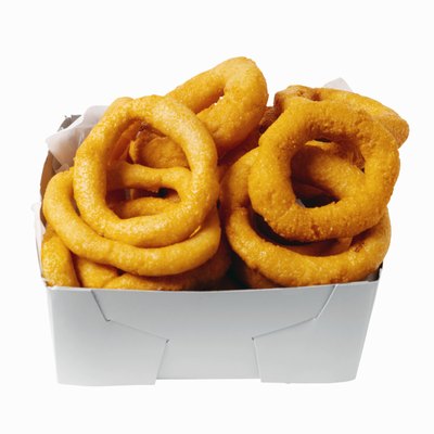 Ciaran Griffin/Stockbyte/Getty Images Onion rings are tasty, but can be toxic to dogs.