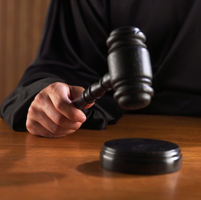 Brand X Pictures/Brand X Pictures/Getty Images Avoid bank account garnishment by preventing a court judgment.