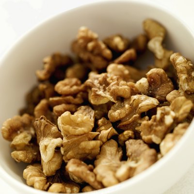 Stockbyte/Stockbyte/Getty Images Walnuts are a concentrated source of calories and nutrients.