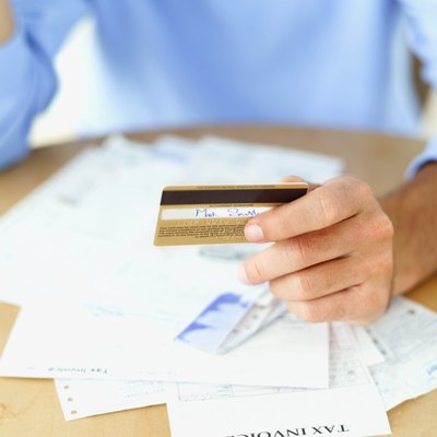 George Doyle/Stockbyte/Getty Images Make a plan before you dive in to tackle your debt.