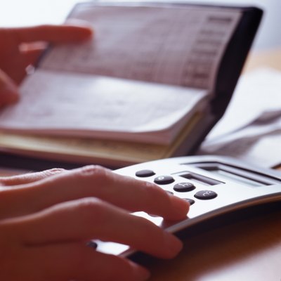 Ryan McVay/Photodisc/Getty Images Cutting taxes puts more money in your budget.