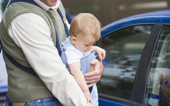 Carry infants in a baby sling to keep your hands free to juggle luggage and other children.