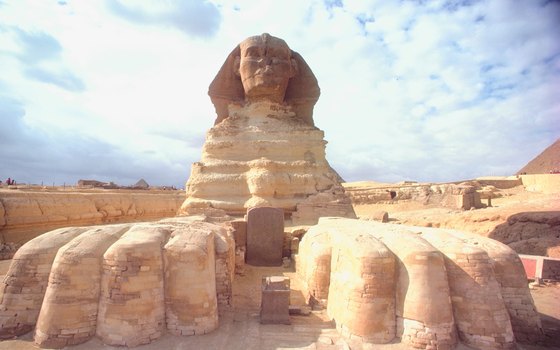 The Sphinx rests its giant paws outside Cairo, Egypt.