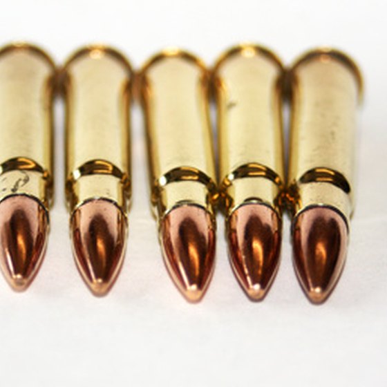 According to Delta Airlines and the Transportation Security Administration, ammunition may be packed in the same container as a weapon.