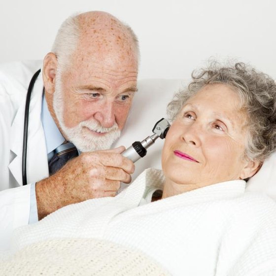 A doctor is examining a patient's ears.