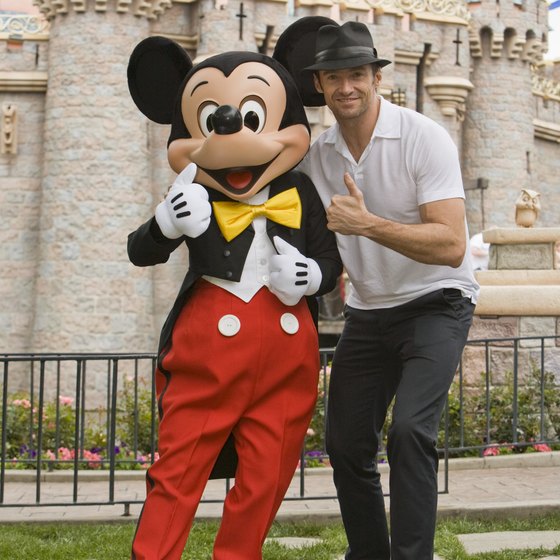 Actor Hugh Jackman hangs with Mickey Mouse at Disneyland.