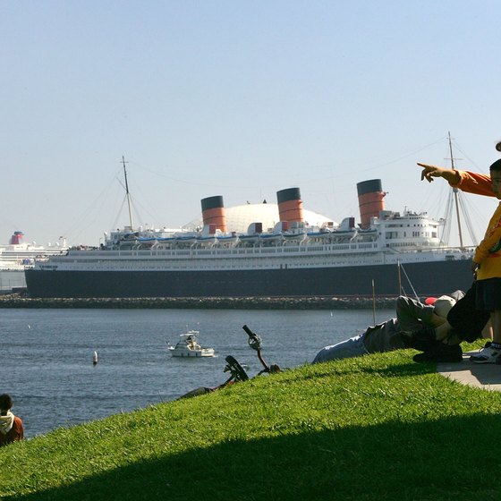 The Queen Mary permanently docked in Long Beach, shadowed by the Queen Mary II, still afloat.