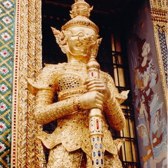 A statue guards the entrance to one of Bangkok's many Bhuddist temples.