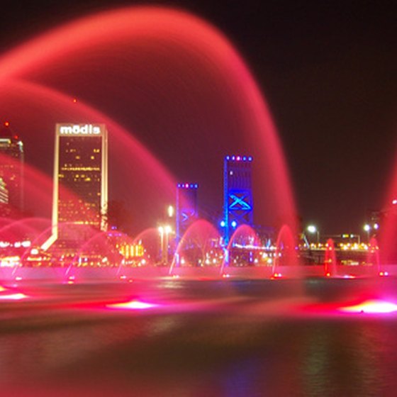 An illuminated fountain and the Jacksonville skyline at night
