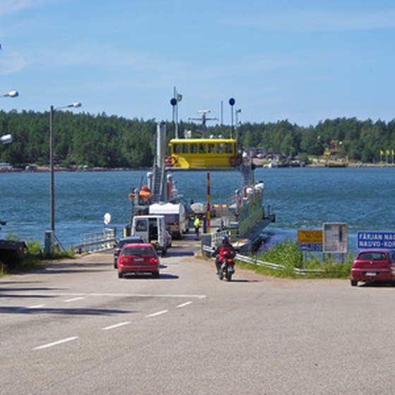 Cars driving onto a ferry.