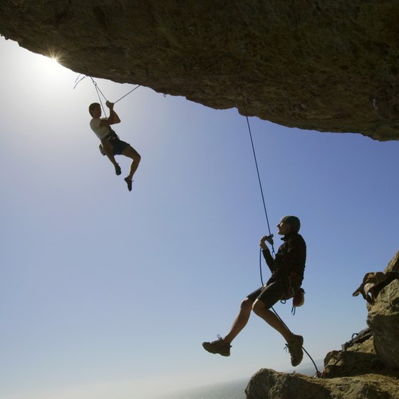Rappelling involves using ropes to descend rock faces.