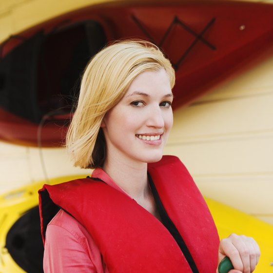 Slip on a life preserver before your river kayak adventure.