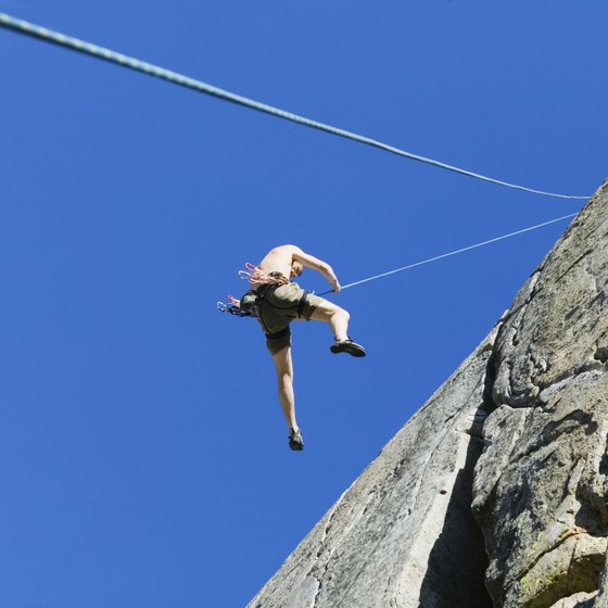 Climbers descend cliffs by rappelling.