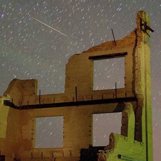The Rhyolite ghost town during a meteor shower.