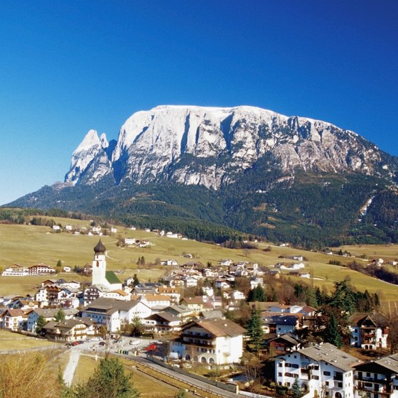 The Dolomite landscape features mountain peaks and valley villages.