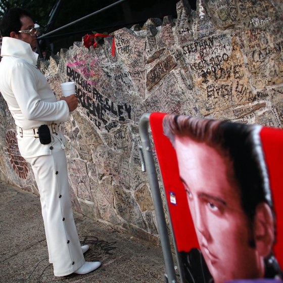 Fan mementos and messages on Graceland's stone wall.