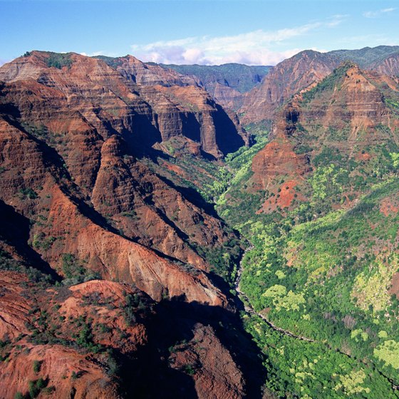 Hiking in beautiful Waimea Canyon in Kauai, Hawaii is reminiscent of the Grand Canyon.