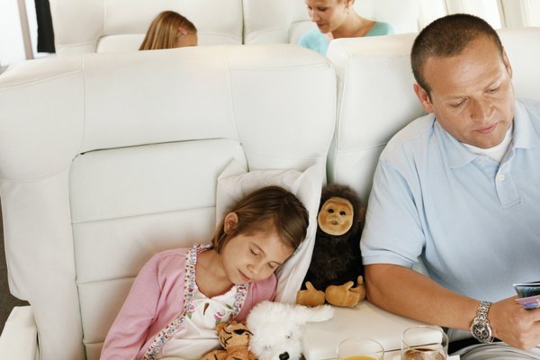 Family Sitting in an Aircraft Cabin and Passengers Sitting in the Background