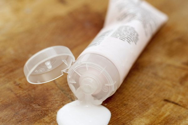 close-up of open leaking tube of cream