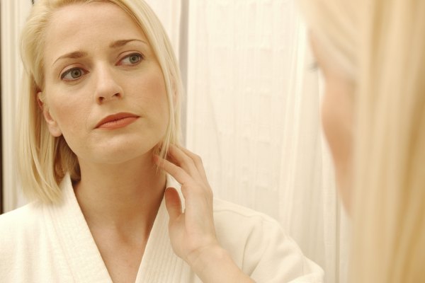 Woman checking herself for wrinkles in mirror