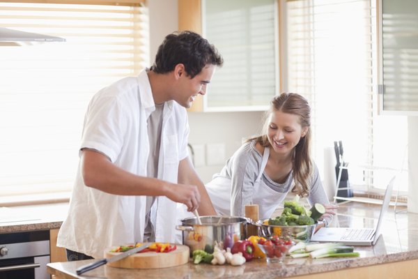 Couple using the internet to look up recipe