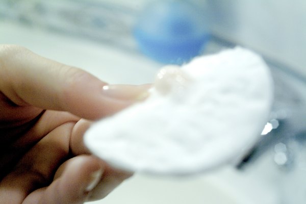 Close-up of a cotton pad in a woman's hand