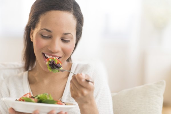 Woman Eating Fresh Salad At Home