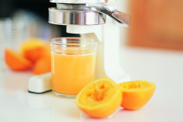 Juicer With a Glass of Fresh Orange Juice