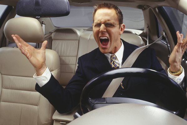 Annoyed businessman with road rage, shouting in car