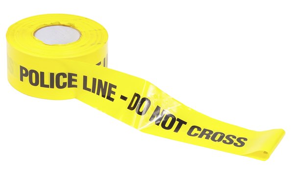 Rodea la escena del crimen con cinta policial amarilla.