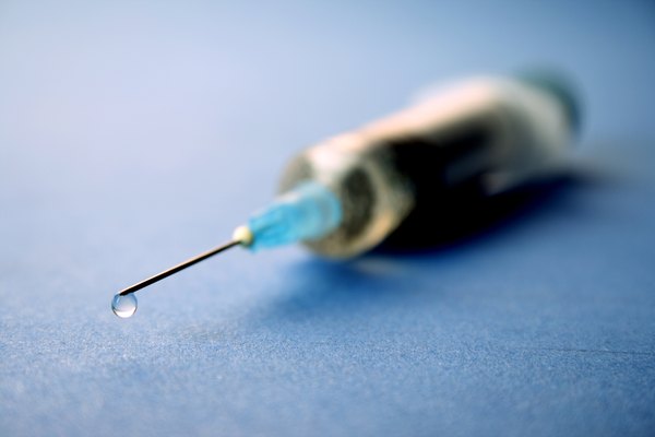 Close up shot of water squirting out of a needle