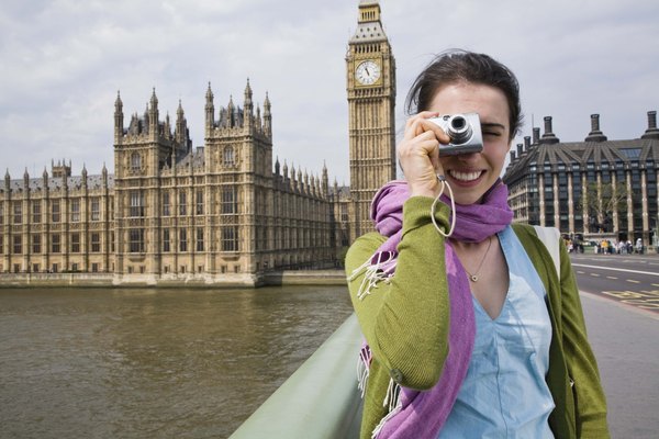 Tourist with digital camera by Big Ben, London, England