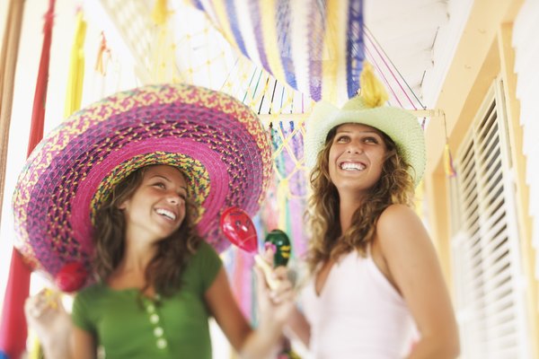 Smiling women with sombreros maracas