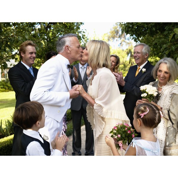 How To Incorporate Stepchildren Into Your Wedding Vows Our A Bride And Groom Kiss During Wedding Ceremony