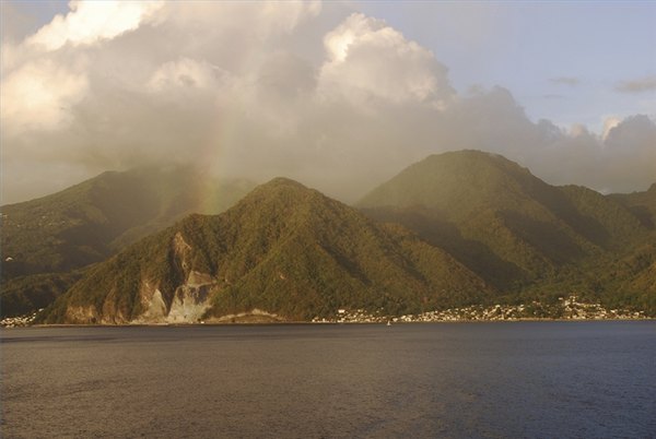 Clouds are piled up by prevailing winds against a range of mountains.