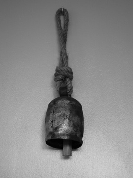 bell image by Liz from Fotolia.com A small bell is a handy tool to alert you when your dog needs to go outside.