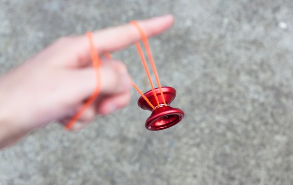 Wind the string around the yo-yo, and place the string loop around your middle finger.