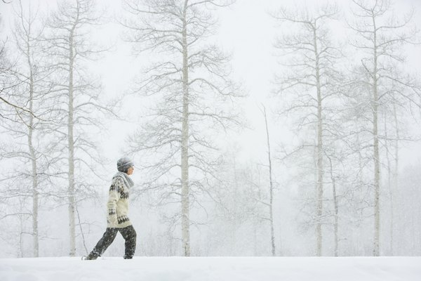 Woman walking in snow.