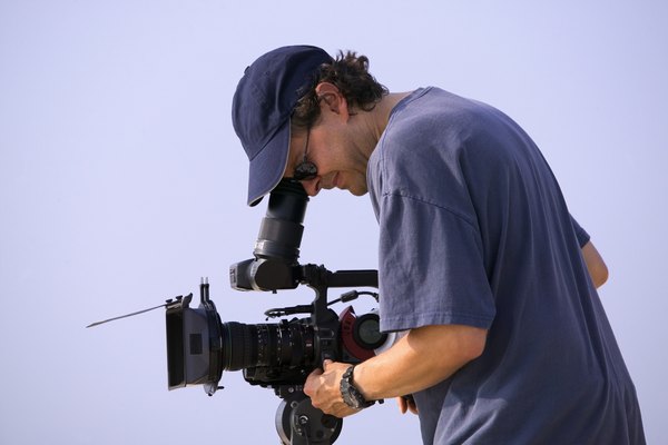 A man uses a digital video camera.