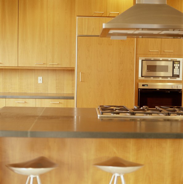 A kitchen exhaust fan lowers pressure by drawing air from the home.