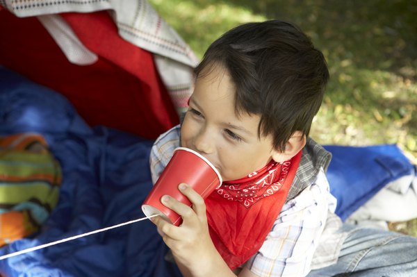 Boy talking on a string phone