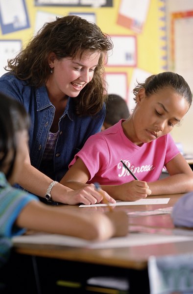 Photo Credit: Brand X Pictures/Brand X Pictures/Getty Images Aides may work one-on-one with students.