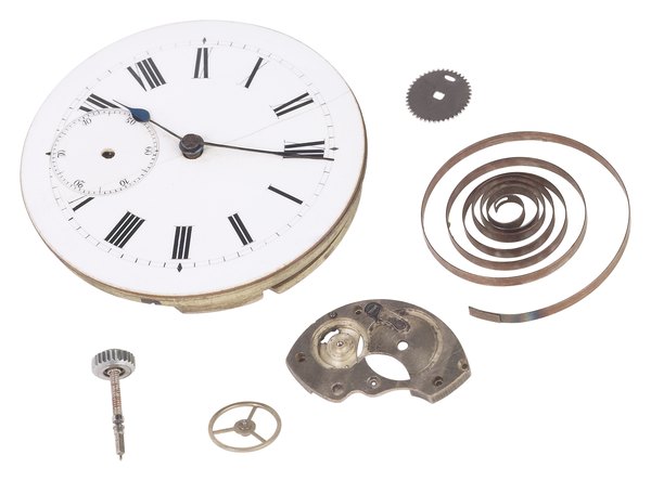 Pieces of a clock with electromagnet and coil.