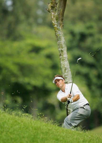 Nick Dougherty makes a flat swing to keep the ball below a tree branch.