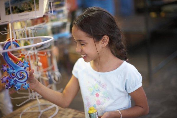 Young girl looking at colorful toy in store.